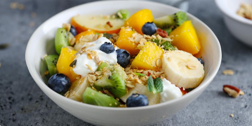 Muesli with fruits served in bowl